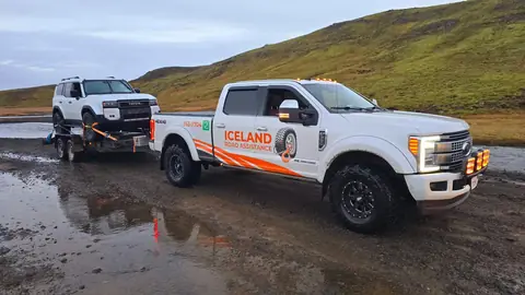 Iceland Road Assistance rescue truck towing a 4x4 vehicle on a trailer in Iceland